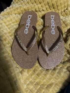 bebe Glitter Flip Flops in Gold Metallic